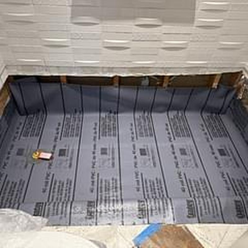 Shower pan liner installed in guest bathroom floor