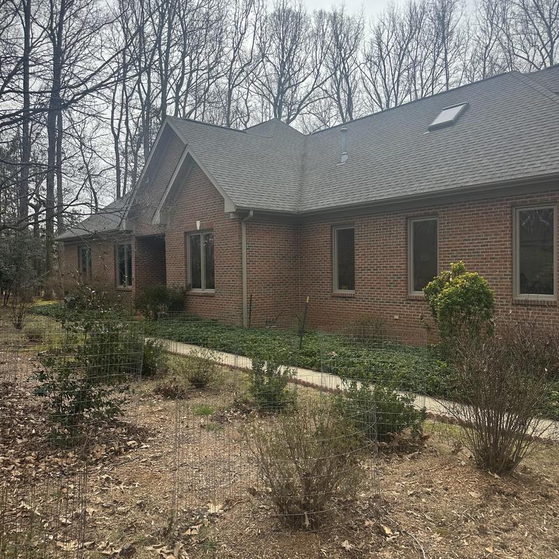 Roof skylight and gutter system on brick house exterior