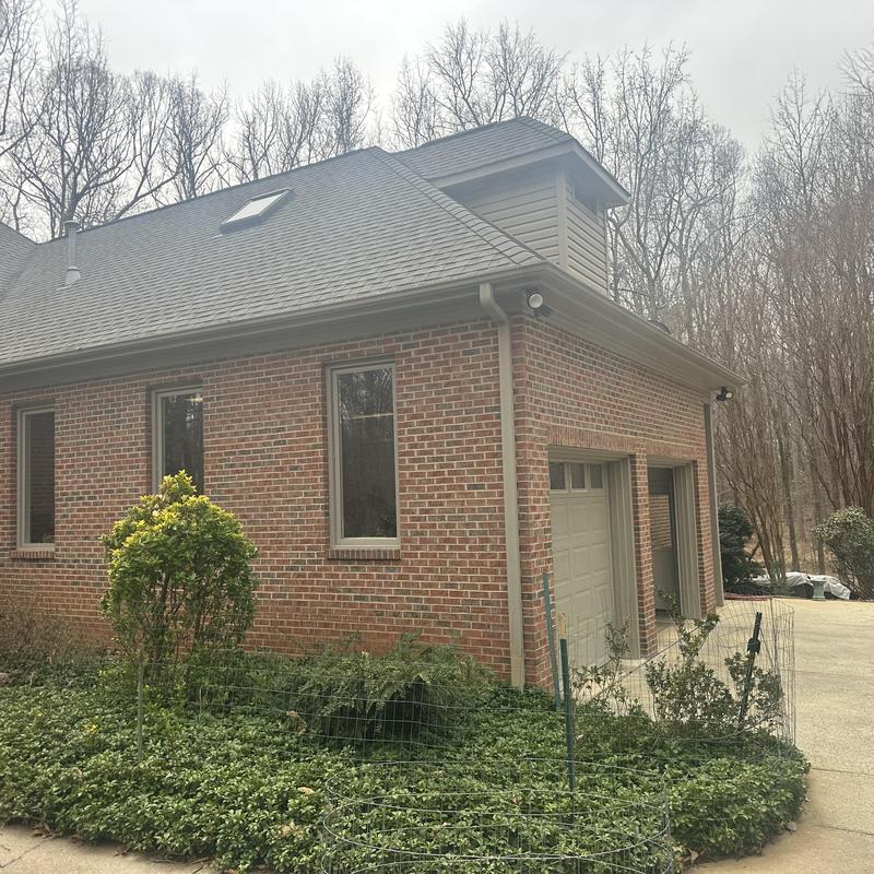 Skylight and roof gutter system on brick house exterior