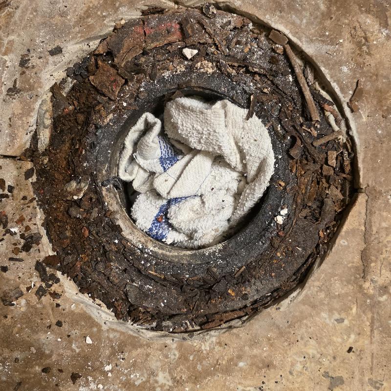 Tub drain with debris and cloth inside opening