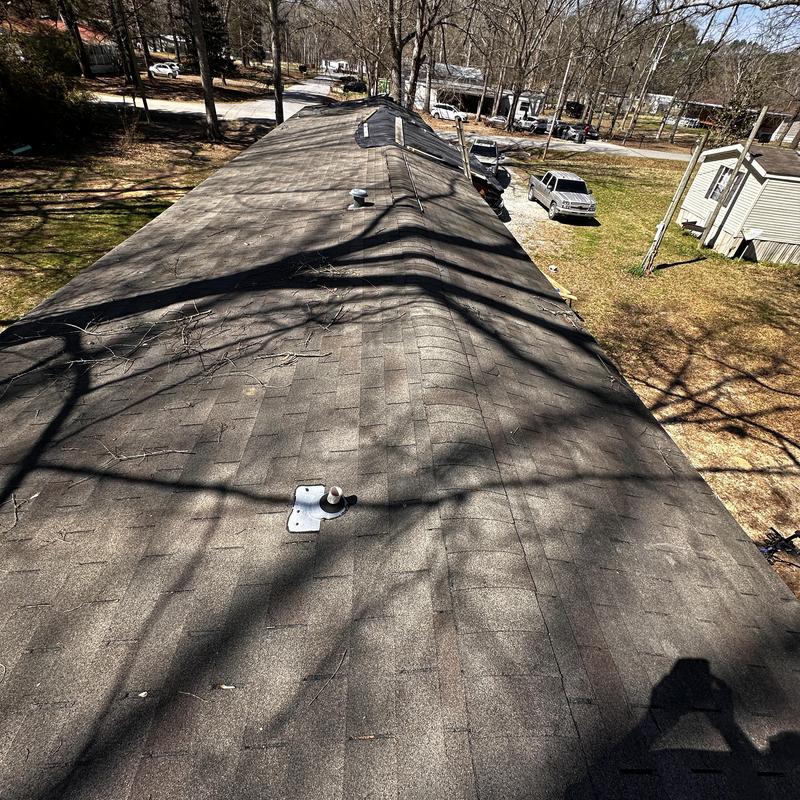 Asphalt shingle roof with blown off shingles and nail pops