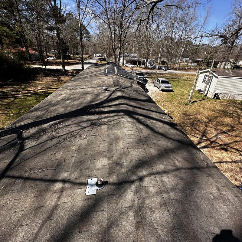 Asphalt shingle roof with blown-off shingles and nail pops