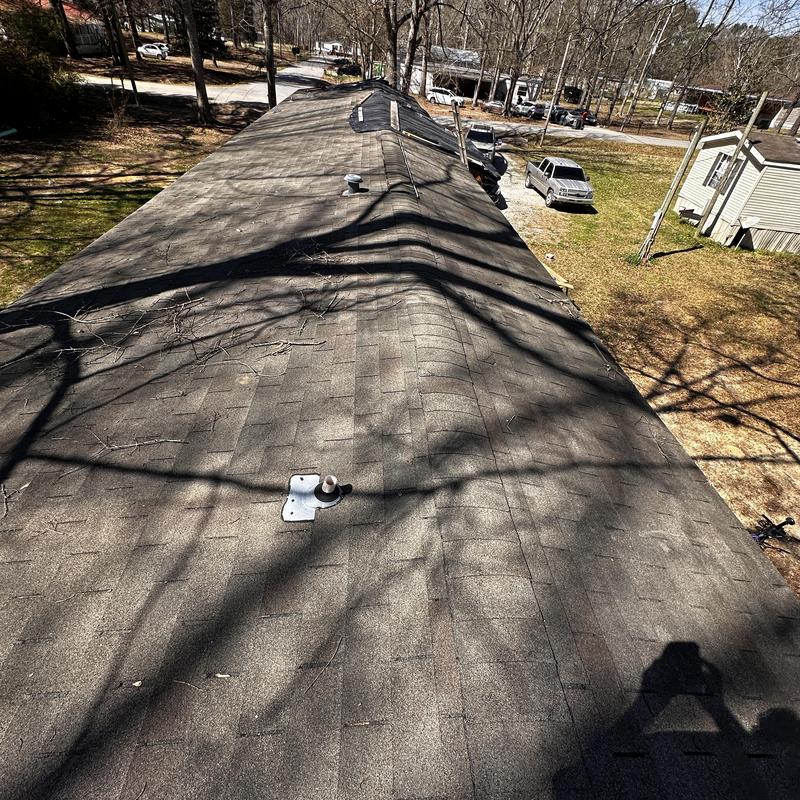 Asphalt shingle roof with exposed deck and nail pops