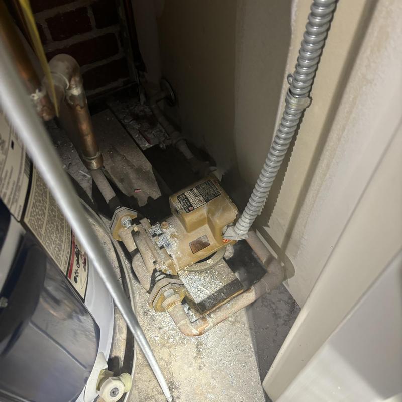 Boiler pump and piping in a utility closet