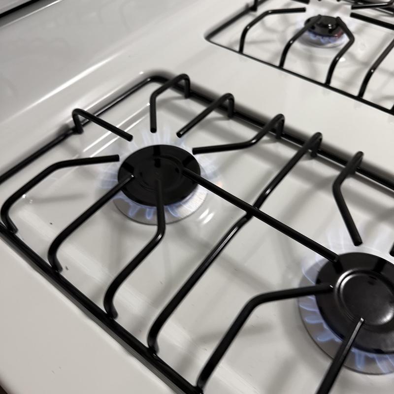 Gas stove burners with blue flames burning evenly