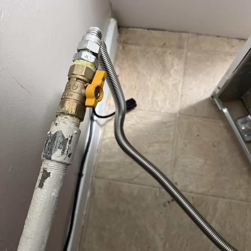 Gas valve with yellow handle and flexible tubing installation