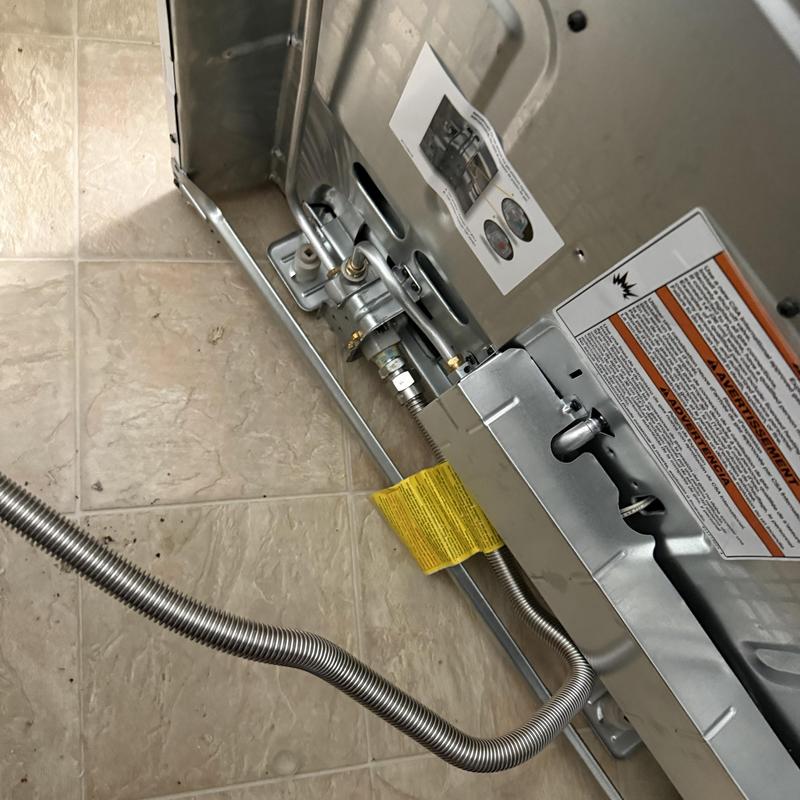 Gas valve and flexible gas line on stove back panel