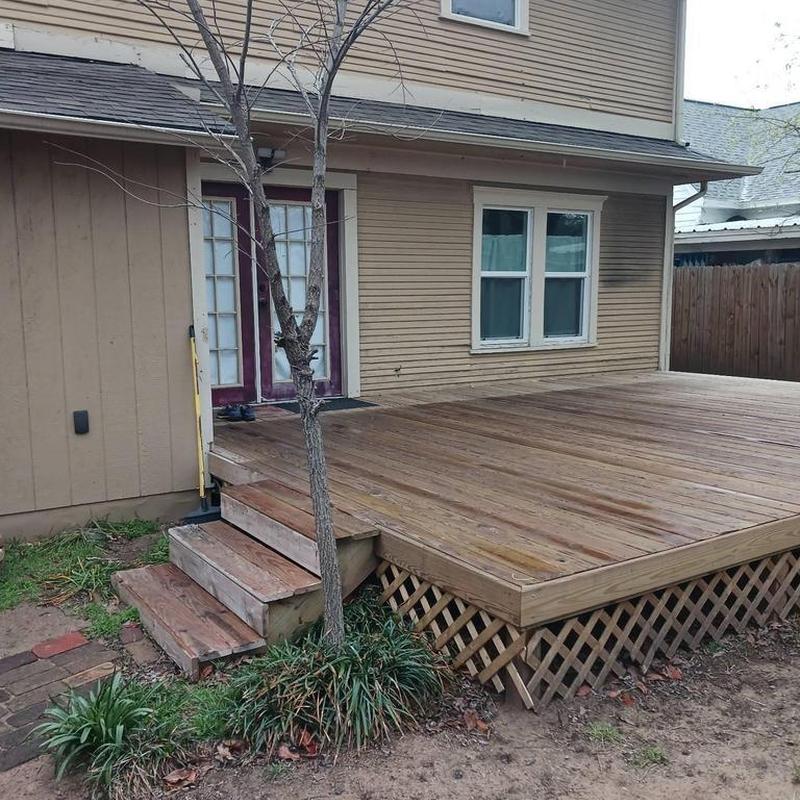 Wooden backyard deck with stairs and lattice skirting