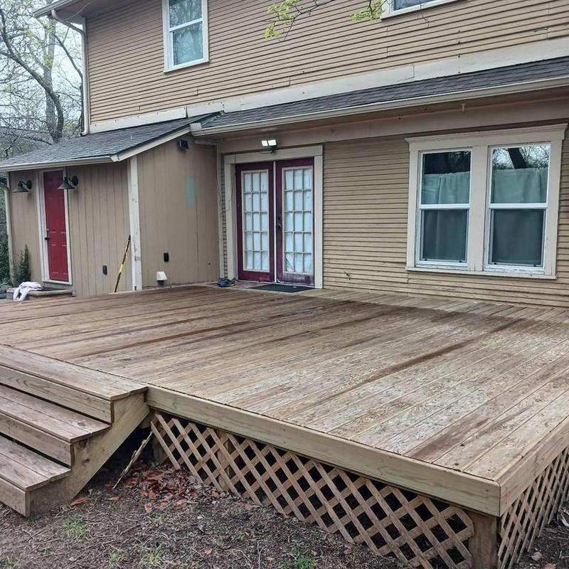Wooden backyard deck with steps and lattice skirting