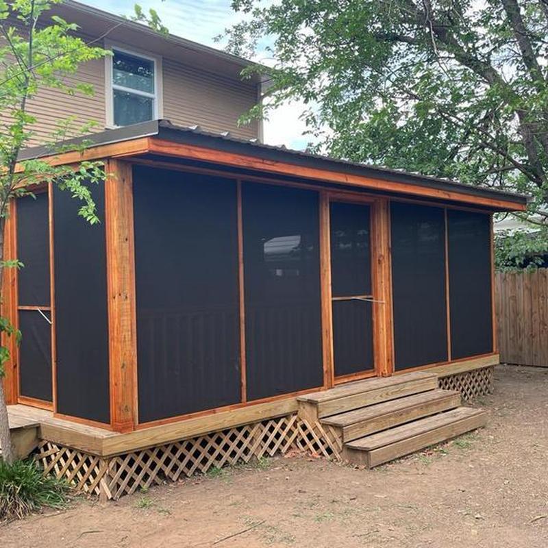 Covered screened patio addition on wooden deck