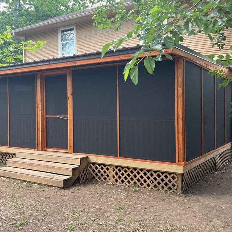 Covered screened patio addition with wooden deck stairs