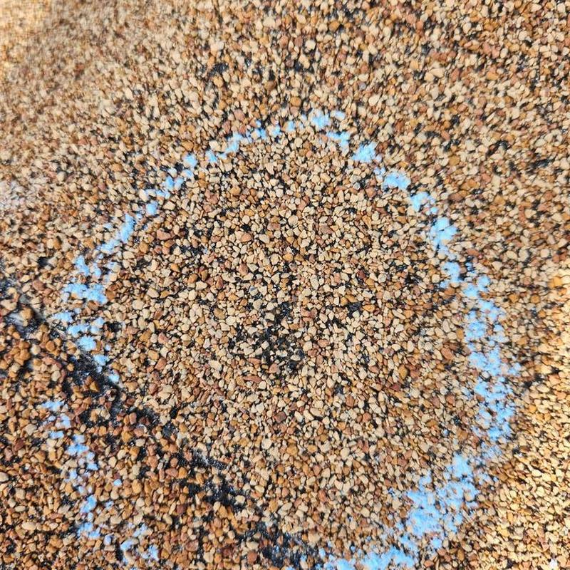 Roof shingle hail damage marked for inspection