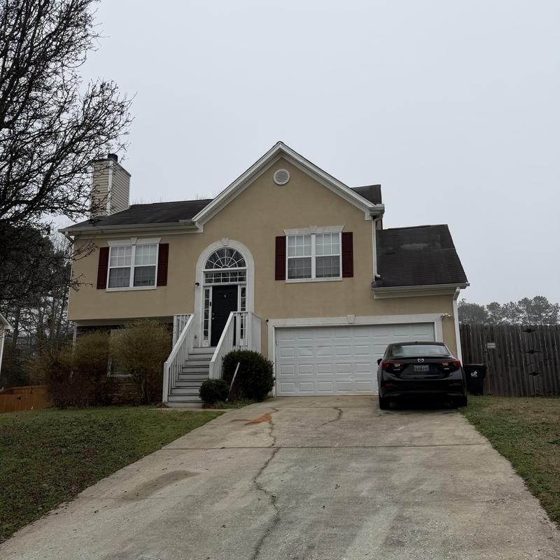 Roof shingles inspection with tarp on two-story house