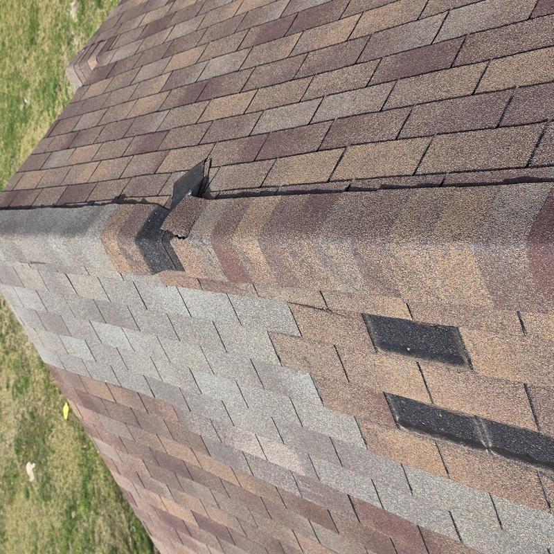 Roof ridge shingles with hail impact damage