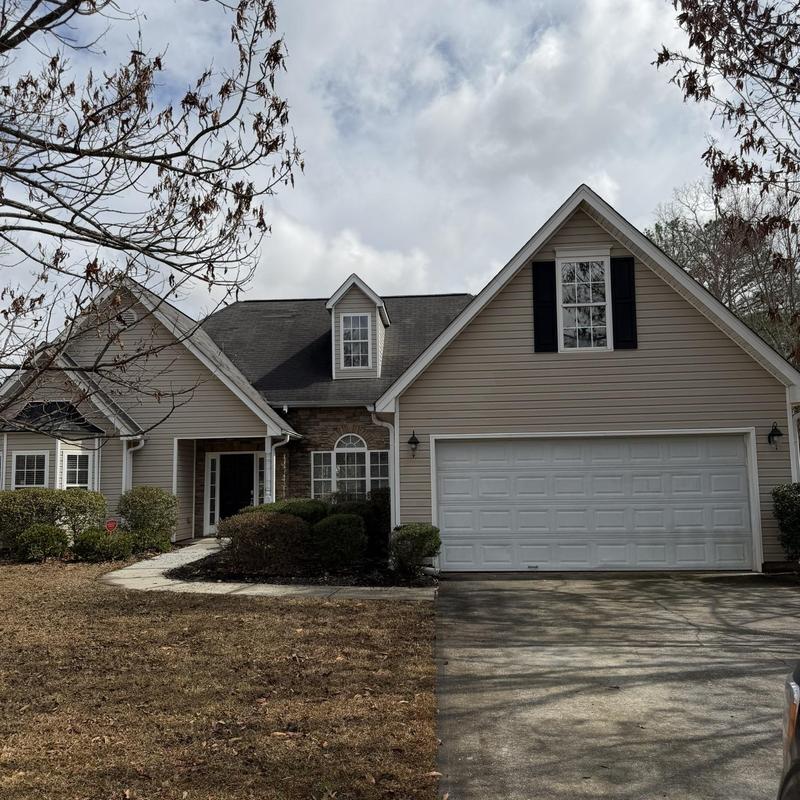 Asphalt shingles on residential roof with replaced sections