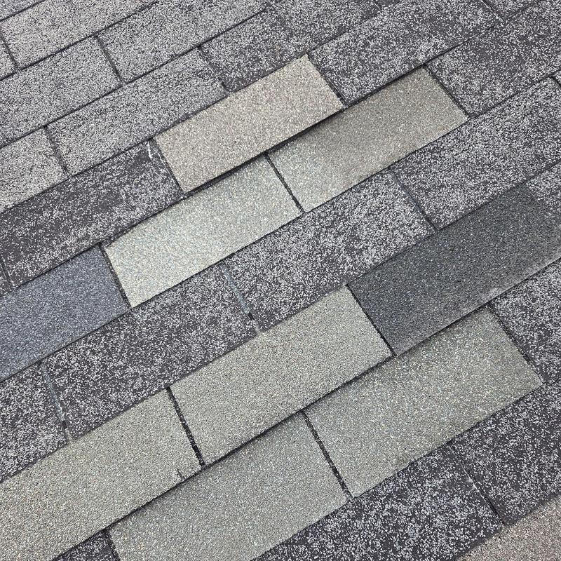 Roof shingles replacement with varied shades on roof surface