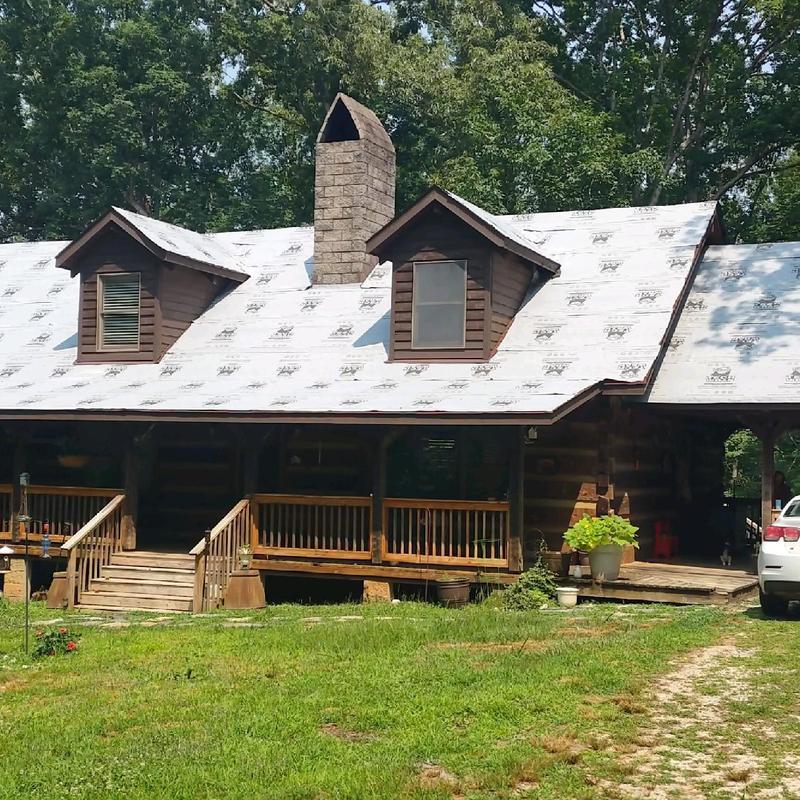 Metal standing seam roof underlayment on log home Metal standing seam roof underlayment on log home