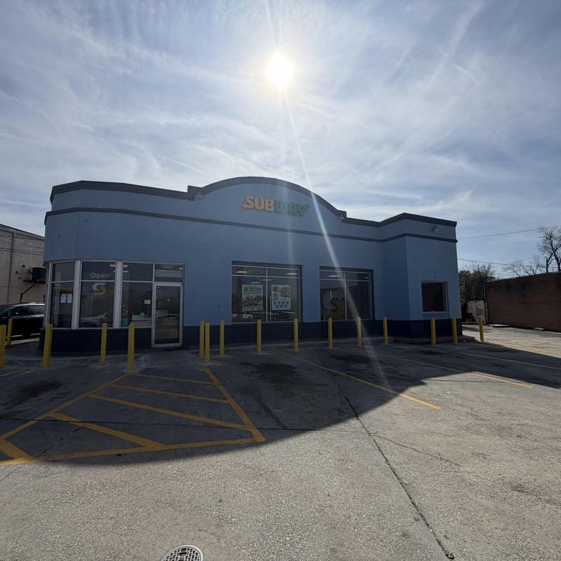 Commercial roof maintenance at Subway restaurant exterior