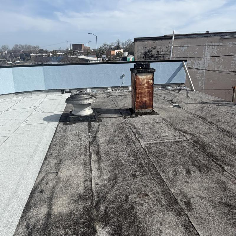 Commercial flat roof with ventilation and chimney units