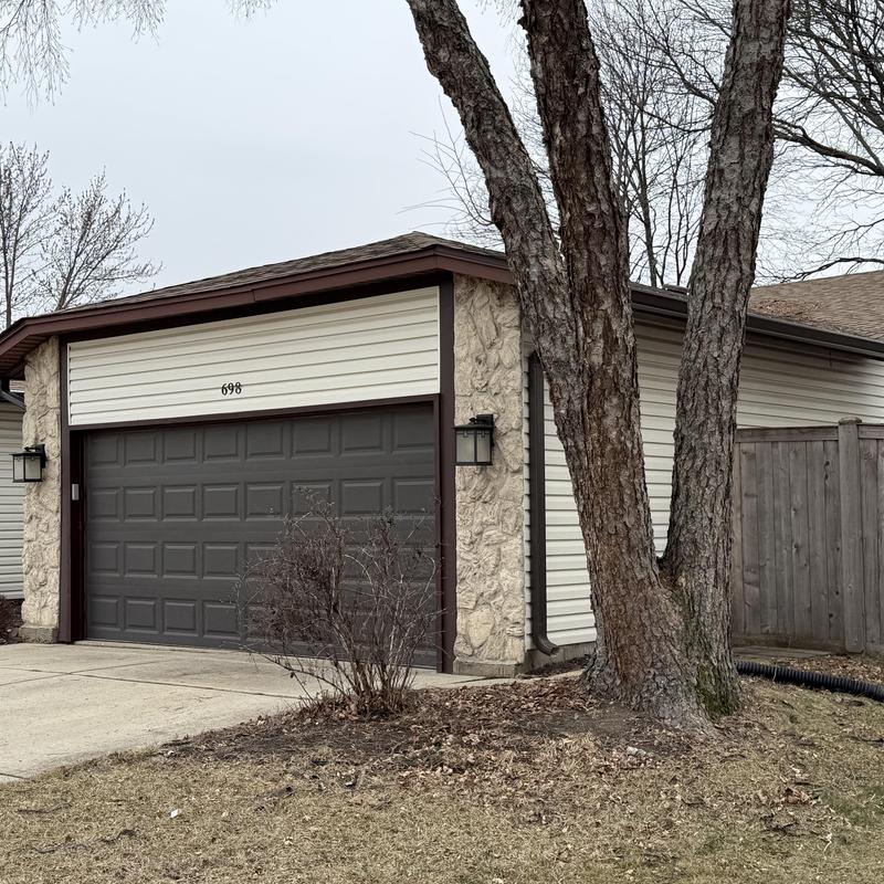 Gutter downspout and guard on residential garage