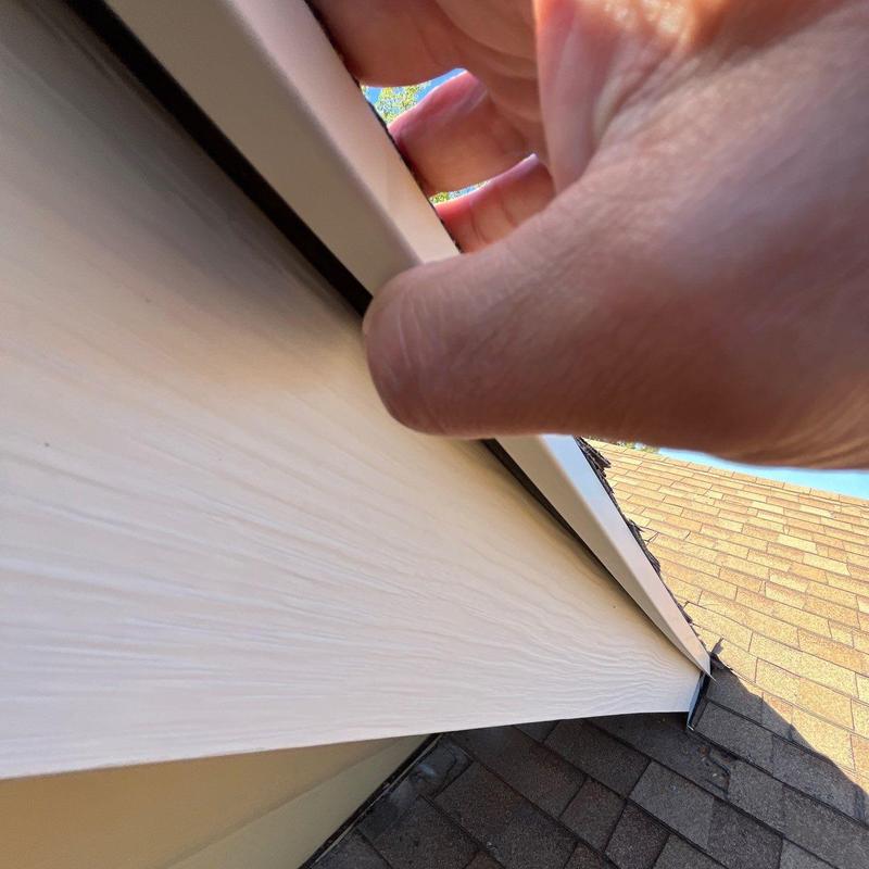 Roof edge flashing inspection and hand assessment on shingles