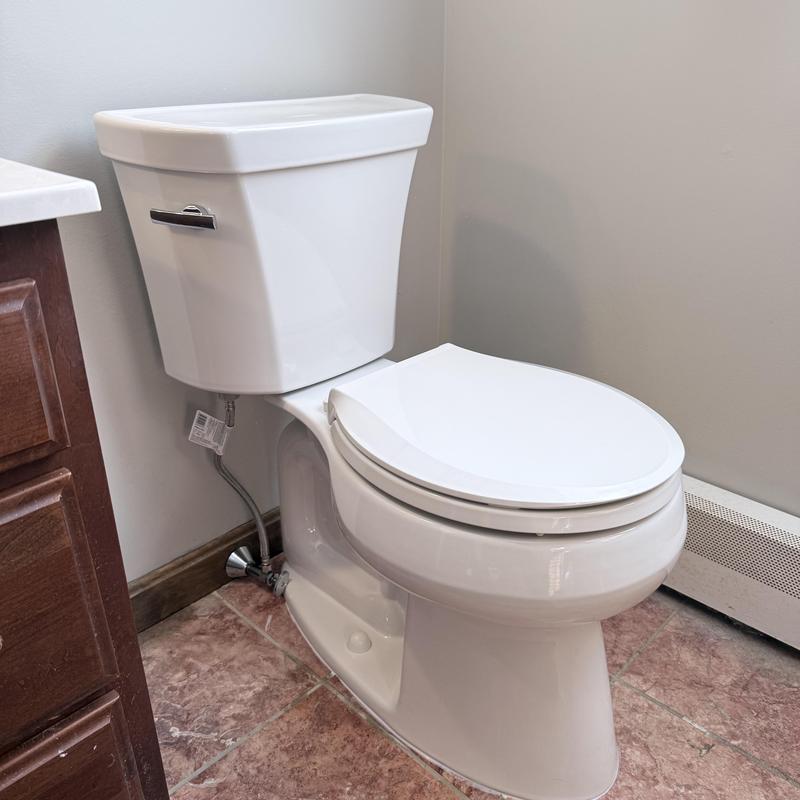 Toilet with new shut off valve installed in bathroom