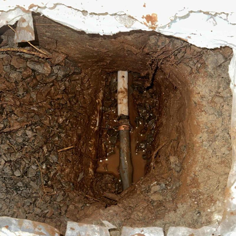 Underground water pipe exposed in trench for repair Underground water pipe exposed in trench for repair