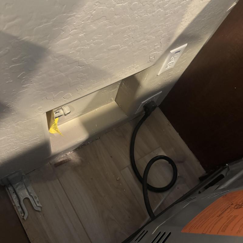 Gas line space behind stove with electrical outlet