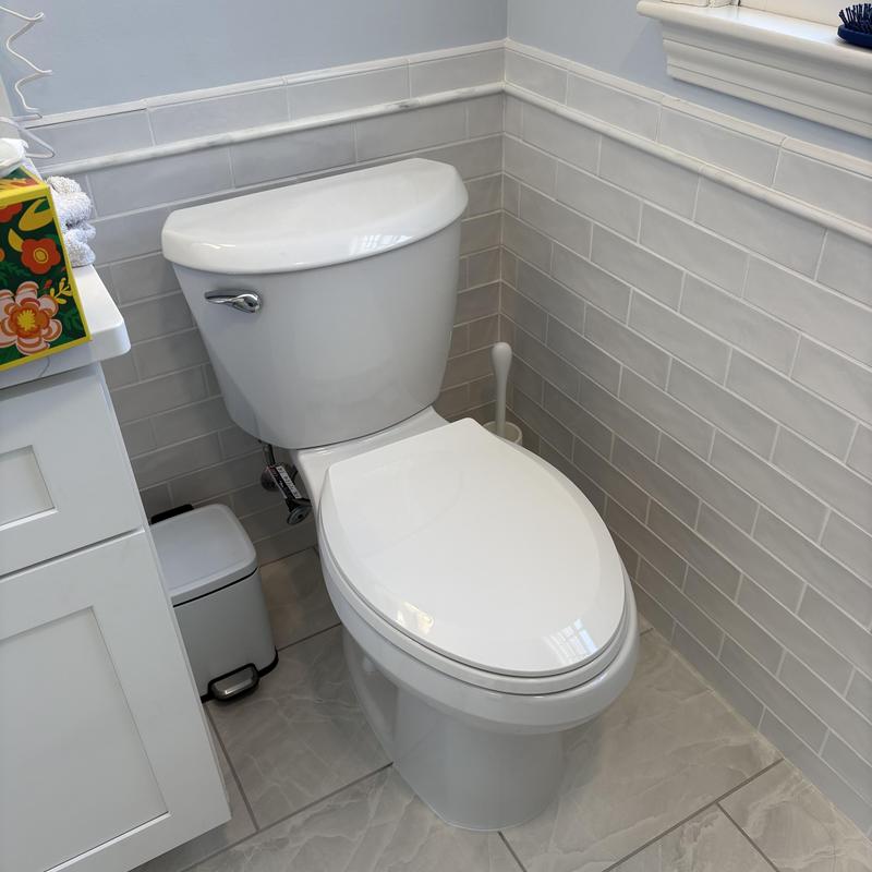 Toilet with new bolts, wax ring, and caulking installed