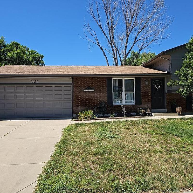 Shingle roof with wind damage on residential house Shingle roof with wind damage on residential house