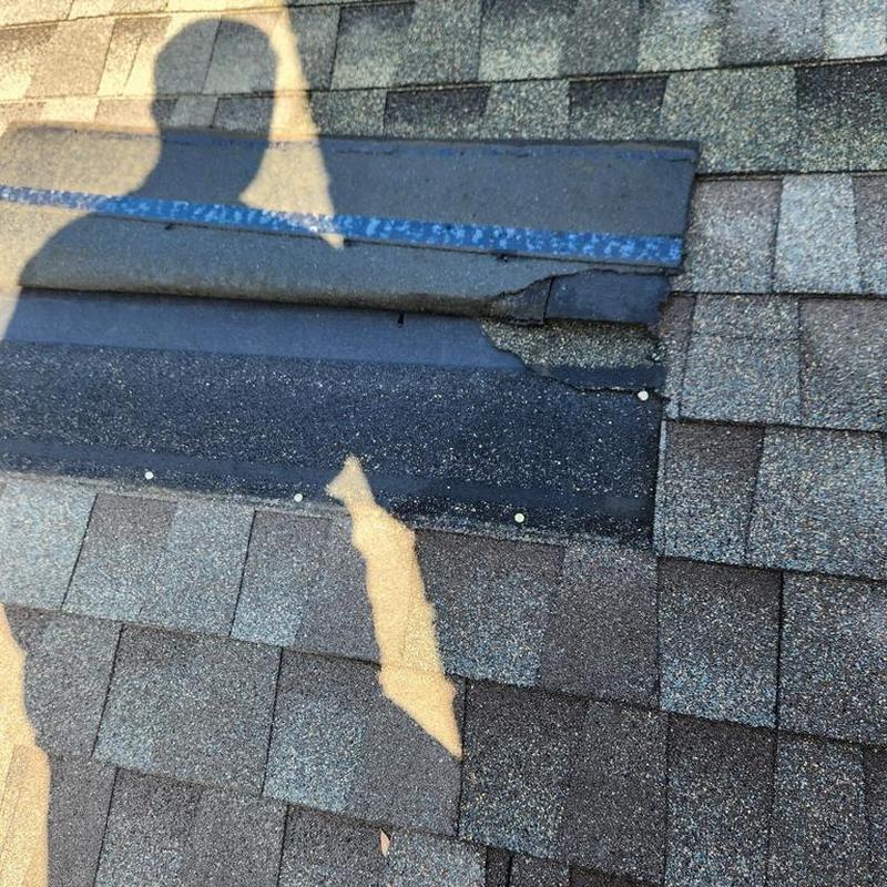 Roof shingles with damaged underlayment exposed