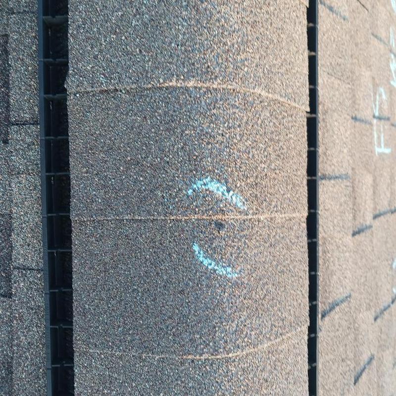 Roof shingles with chalk markings during inspection
