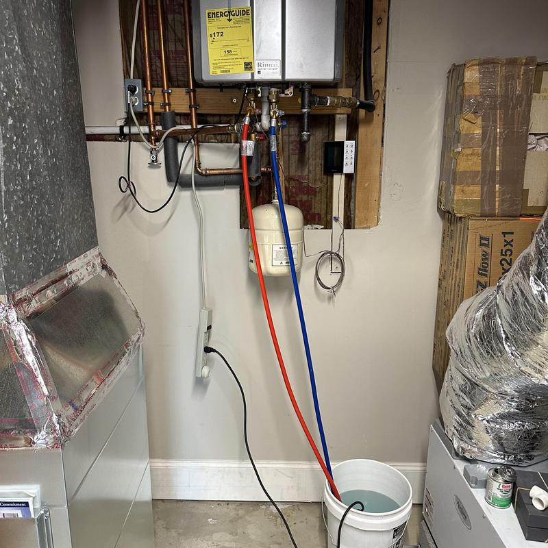 Tankless water heater with flushing hoses and bucket Tankless water heater with flushing hoses and bucket