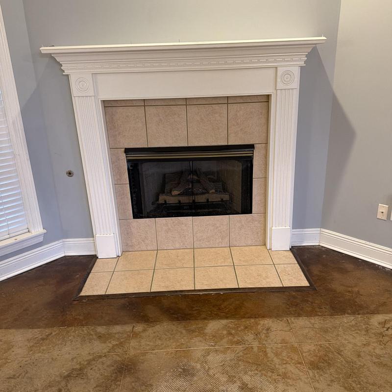 Fireplace with tile surround and white mantel