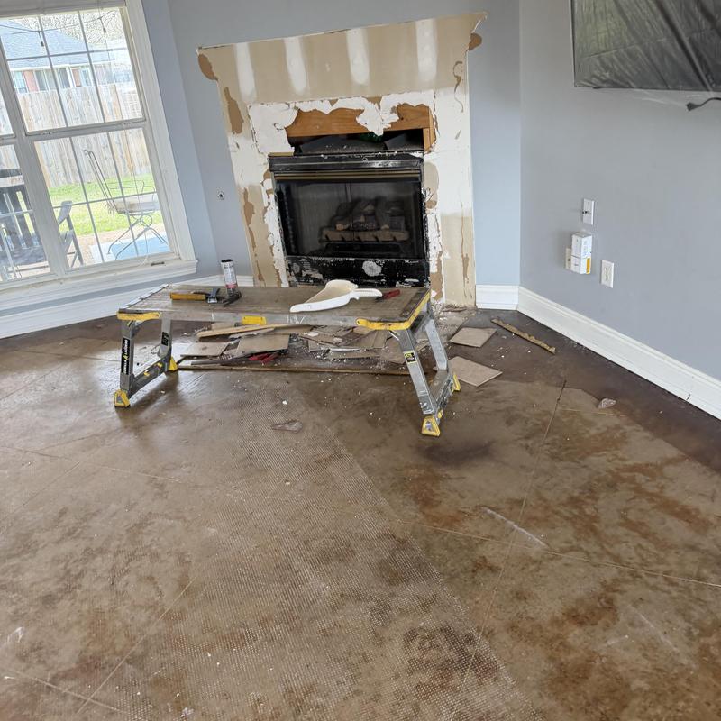 Fireplace surround demolition with workbench and tools