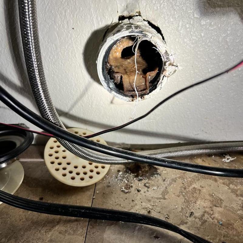 Kitchen sink drain pipe with clog and debris inside