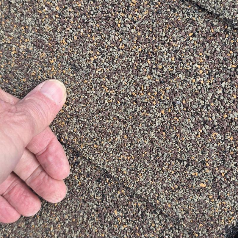 Asphalt shingles with hail damage close-up inspection