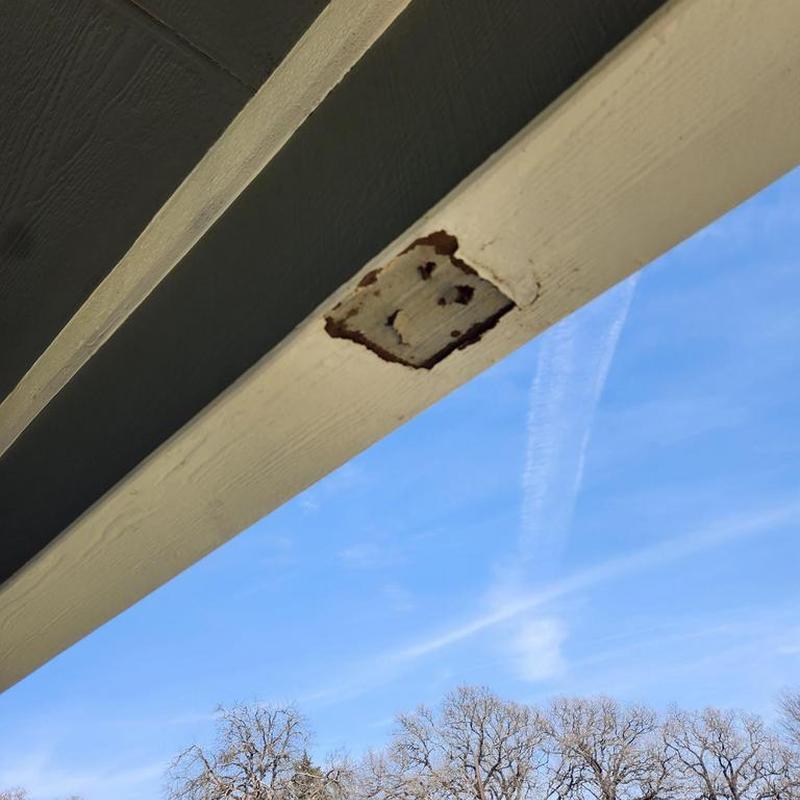 Patio ceiling wooden post with rot damage