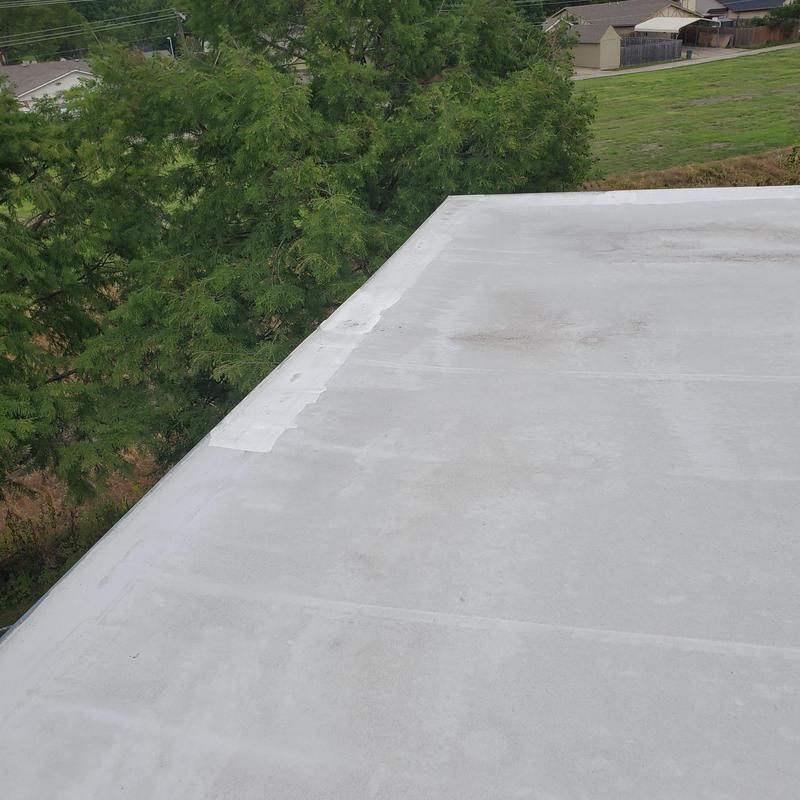 Flat roof surface with hail damage repair patches