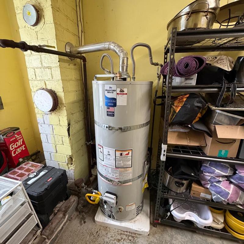 50 gal gas water heater with vent pipe and plumbing