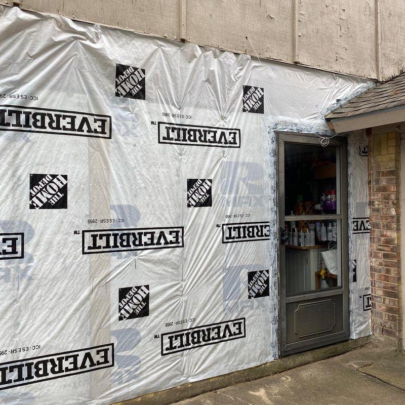 Vapor barrier installation around exterior door and siding