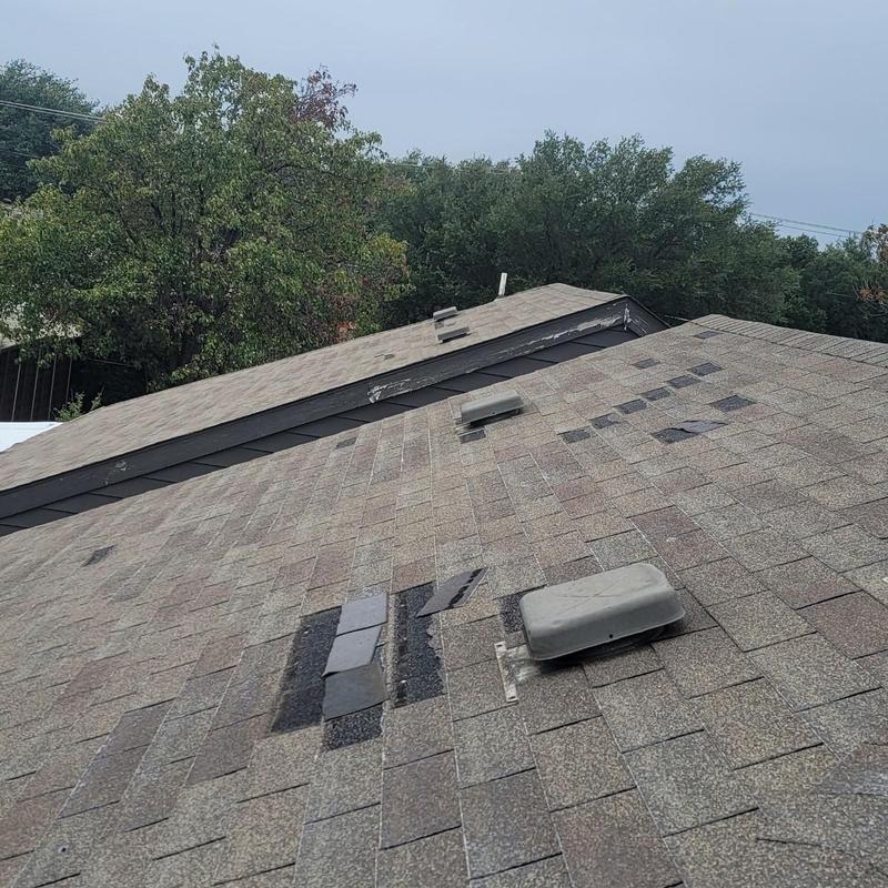 Asphalt shingle roof with hail damage and missing shingles