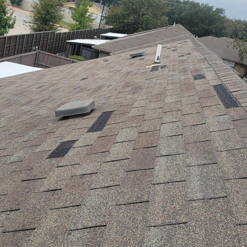 Asphalt shingle roof with hail damage patches