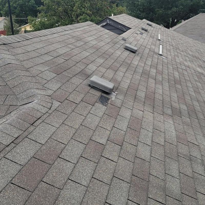 Asphalt shingle roof with hail damage and vents