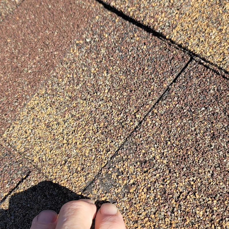 Asphalt shingle roof with hail damage close-up
