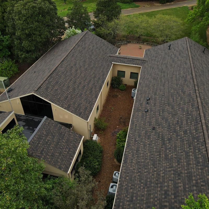 Asphalt shingle commercial roof with multiple vents Asphalt shingle commercial roof with multiple vents