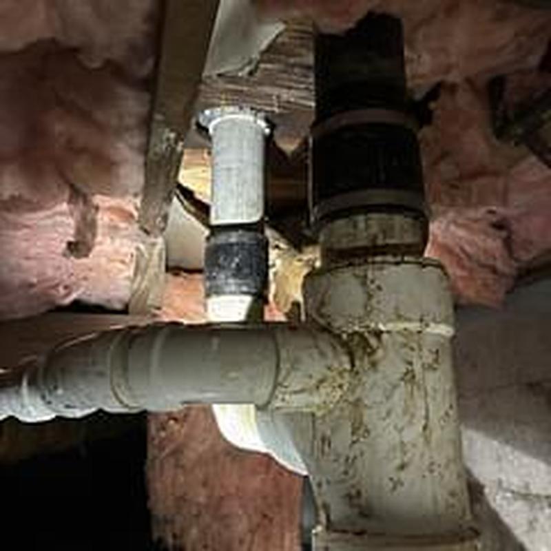 Drain pipe system with new PVC fittings in crawl space