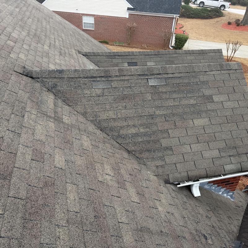 3-tab shingle roof with missing shingles and wear