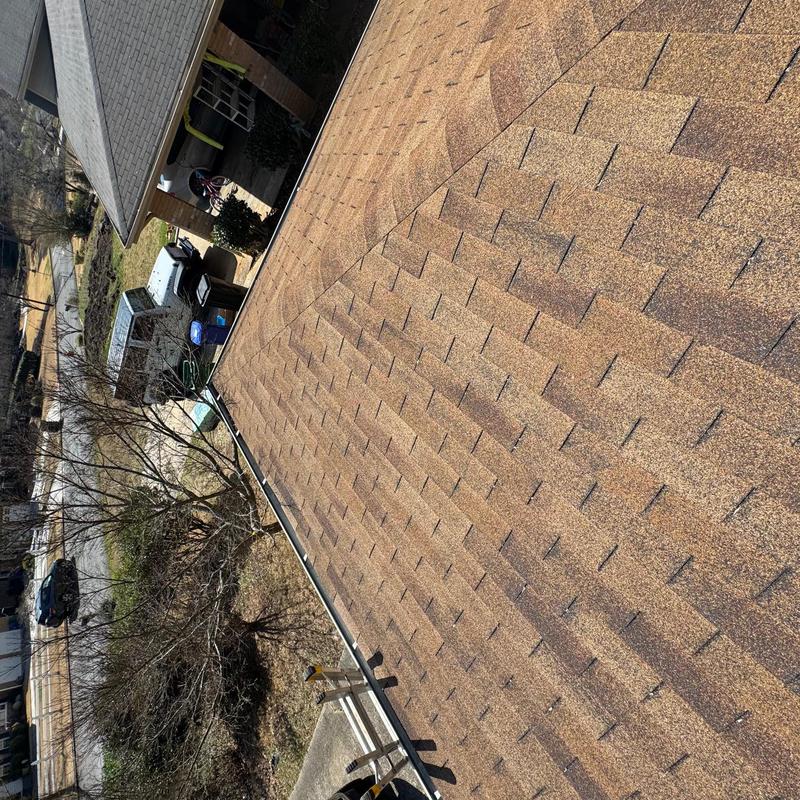 Asphalt shingle roof close-up during inspection