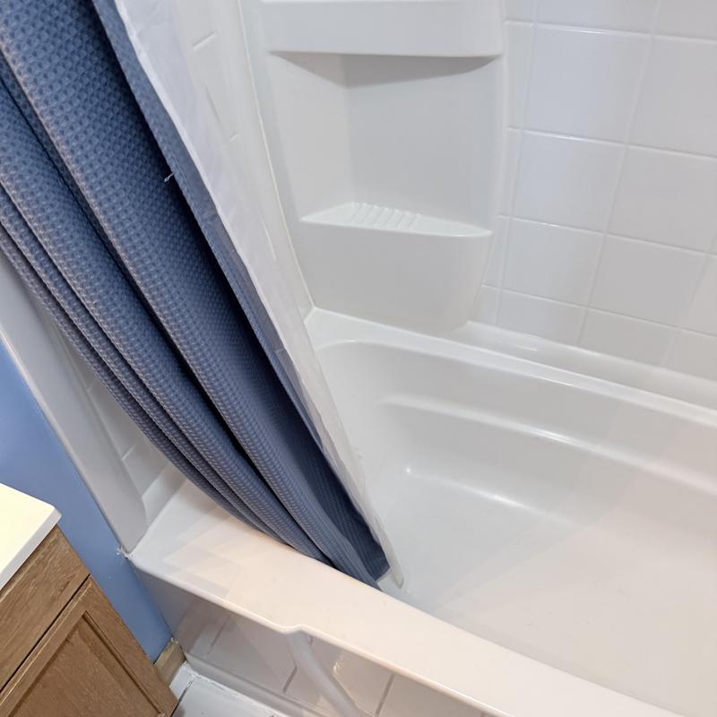 Shower caulking and tub floor with curtain